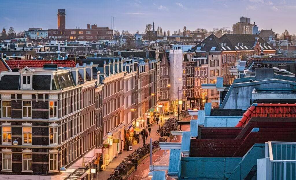 Rooftop view of a Dutch city street at dusk